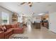 Bright open-concept living area with tile floors, comfortable sofa and views into kitchen and dining at 16163 Pebble Bluff Loop, Winter Garden, FL 34787