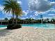 A relaxing view of a pool with water features and plenty of palm trees at 16163 Pebble Bluff Loop, Winter Garden, FL 34787