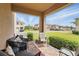 Covered brick porch featuring comfortable seating and a view of the well-manicured lawn at 16163 Pebble Bluff Loop, Winter Garden, FL 34787
