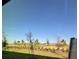 View of the backyard shows a view of the landscaped community and mature trees at 16468 Happy Eagle Dr, Clermont, FL 34714