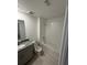 Well-lit bathroom featuring a granite countertop, tiled floor, and shower-tub combination with white tile at 16468 Happy Eagle Dr, Clermont, FL 34714