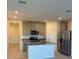Modern kitchen with stainless steel appliances, granite countertops, and a spacious island at 16468 Happy Eagle Dr, Clermont, FL 34714