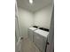 Well-lit laundry room with brand new white washer and dryer appliances at 16468 Happy Eagle Dr, Clermont, FL 34714
