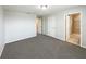 Spacious bedroom with neutral carpet, multiple doors, and an ensuite bathroom at 16518 Brook Springs Aly, Winter Garden, FL 34787