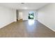 Spacious living room with ceramic tile flooring and sliding glass doors to the backyard at 16518 Brook Springs Aly, Winter Garden, FL 34787