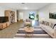 Open living room featuring neutral decor, modern furnishings, and sliding glass doors to the backyard at 16518 Brook Springs Aly, Winter Garden, FL 34787
