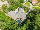 An elevated view displays the home's premium landscaping, tile roof, and pool at 1724 Cottonwood Creek Pl, Lake Mary, FL 32746