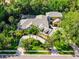 Aerial view of stunning home showcasing the lush landscaping, and circular driveway at 1724 Cottonwood Creek Pl, Lake Mary, FL 32746