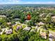 Beautiful aerial view of a suburban home nestled among lush trees in a well-established neighborhood at 1724 Cottonwood Creek Pl, Lake Mary, FL 32746