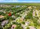 Stunning aerial view of a home in a leafy neighborhood with mature trees, near a tranquil lake and green space at 1724 Cottonwood Creek Pl, Lake Mary, FL 32746