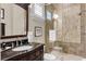 Well-lit bathroom featuring a glass-enclosed shower with detailed tile work and a stylish vanity at 1724 Cottonwood Creek Pl, Lake Mary, FL 32746