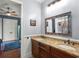 Bathroom with a granite countertop, double sinks, and decorative mirror at 1724 Cottonwood Creek Pl, Lake Mary, FL 32746