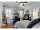 Stylish bedroom with wood floors, large bed, black dresser, and cozy decor at 1724 Cottonwood Creek Pl, Lake Mary, FL 32746