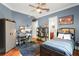 Bedroom featuring blue walls, a ceiling fan, and a view to a bathroom at 1724 Cottonwood Creek Pl, Lake Mary, FL 32746
