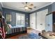 Bedroom featuring a ceiling fan, blue walls, a window, and a desk at 1724 Cottonwood Creek Pl, Lake Mary, FL 32746