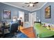 Comfortable bedroom featuring hardwood floors, blue walls, a desk, and a bathroom at 1724 Cottonwood Creek Pl, Lake Mary, FL 32746