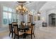 The dining room features a large chandelier and window bringing in ample natural light at 1724 Cottonwood Creek Pl, Lake Mary, FL 32746