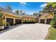 Spacious circular driveway leading to multiple garage spaces, surrounded by lush landscaping at 1724 Cottonwood Creek Pl, Lake Mary, FL 32746