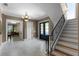 Inviting foyer with staircase, chandelier, and views into other elegantly appointed rooms at 1724 Cottonwood Creek Pl, Lake Mary, FL 32746