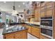 Stunning kitchen featuring custom cabinets, stone accents, double ovens, and stainless steel appliances at 1724 Cottonwood Creek Pl, Lake Mary, FL 32746