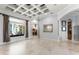 Spacious living room with large windows, coffered ceilings, and a view of the backyard at 1724 Cottonwood Creek Pl, Lake Mary, FL 32746