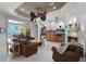 The spacious living room features a fireplace, wet bar and two ceiling fans at 1724 Cottonwood Creek Pl, Lake Mary, FL 32746