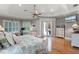 Serene bedroom with tray ceilings, hardwood floors, and access to outdoor patio through elegant French doors at 1724 Cottonwood Creek Pl, Lake Mary, FL 32746