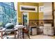 The outdoor kitchen offers a modern grill, bar seating, and backyard views at 1724 Cottonwood Creek Pl, Lake Mary, FL 32746