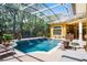 Inviting screened pool and spa area with water features and lush landscaping at 1724 Cottonwood Creek Pl, Lake Mary, FL 32746