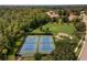 Aerial photo of community tennis courts, beautifully maintained and surrounded by lush greenery, and open space at 1724 Cottonwood Creek Pl, Lake Mary, FL 32746