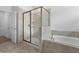 Bathroom showcasing a tiled shower, separate tub, and contemporary fixtures at 1757 Brush Cherry Pl, Ocoee, FL 34761