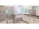 Bathroom boasts a separate shower and soaking tub with neutral tiling and dual sinks at 1757 Brush Cherry Pl, Ocoee, FL 34761