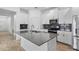 Contemporary kitchen boasts an island with seating, stainless steel appliances, and modern finishes at 1757 Brush Cherry Pl, Ocoee, FL 34761