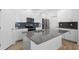 Modern kitchen features a spacious island, stainless steel appliances, and gray backsplash at 1757 Brush Cherry Pl, Ocoee, FL 34761