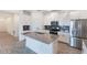 Modern kitchen featuring white cabinets, gray countertops, and stainless steel appliances at 1757 Brush Cherry Pl, Ocoee, FL 34761