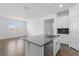 Bright kitchen with a large island, modern appliances, and seamless connection to living spaces at 1757 Brush Cherry Pl, Ocoee, FL 34761