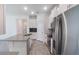 Bright kitchen featuring stainless steel appliances and a center island with a sink at 1757 Brush Cherry Pl, Ocoee, FL 34761