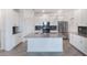 A kitchen with an island, stainless steel appliances, gray countertops, and white cabinets at 1757 Brush Cherry Pl, Ocoee, FL 34761
