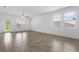 Bright living room with wood-look tile floors and large windows at 1757 Brush Cherry Pl, Ocoee, FL 34761