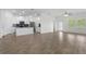 Open-concept living room with wood-look floors and ample natural light, perfect for modern living at 1757 Brush Cherry Pl, Ocoee, FL 34761