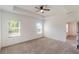 Bright main bedroom with carpet, ceiling fan, and windows offering natural light at 1757 Brush Cherry Pl, Ocoee, FL 34761