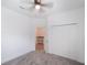 Main bedroom features carpet, ceiling fan, and walk-in closet with attached desk area at 1757 Brush Cherry Pl, Ocoee, FL 34761