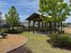 Community picnic pavilion is shaded with picnic tables and near a playground at 1757 Brush Cherry Pl, Ocoee, FL 34761