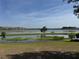 Scenic view of community pond, reflecting homes, enhances the natural beauty of the area at 1757 Brush Cherry Pl, Ocoee, FL 34761