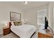 This bedroom features a queen bed, stylish furnishings, and a window for natural light at 17847 Adrift Rd, Winter Garden, FL 34787