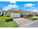 Charming single-Gathering home featuring manicured landscaping and brick-paved driveway at 17847 Adrift Rd, Winter Garden, FL 34787