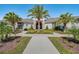 A modern clubhouse with decorative landscaping and a sidewalk at 17847 Adrift Rd, Winter Garden, FL 34787