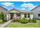 Inviting single-story home with well-manicured lawn, stone accents, and a charming covered entryway at 17847 Adrift Rd, Winter Garden, FL 34787