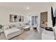 Spacious living room with neutral tones, modern decor, and sliding glass doors at 17847 Adrift Rd, Winter Garden, FL 34787