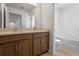 Bathroom featuring double sinks, dark wood cabinets, and a separate toilet and shower area at 2055 Town Pasture Dr, Eustis, FL 32726